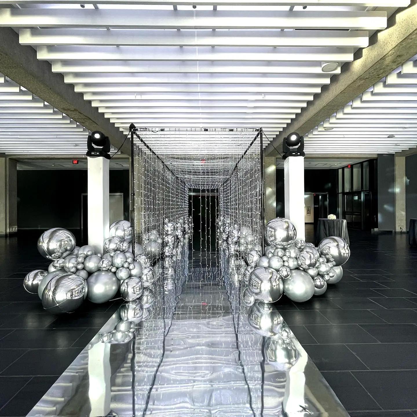 A mirrored-sphere entrance installation in a venue lobby
