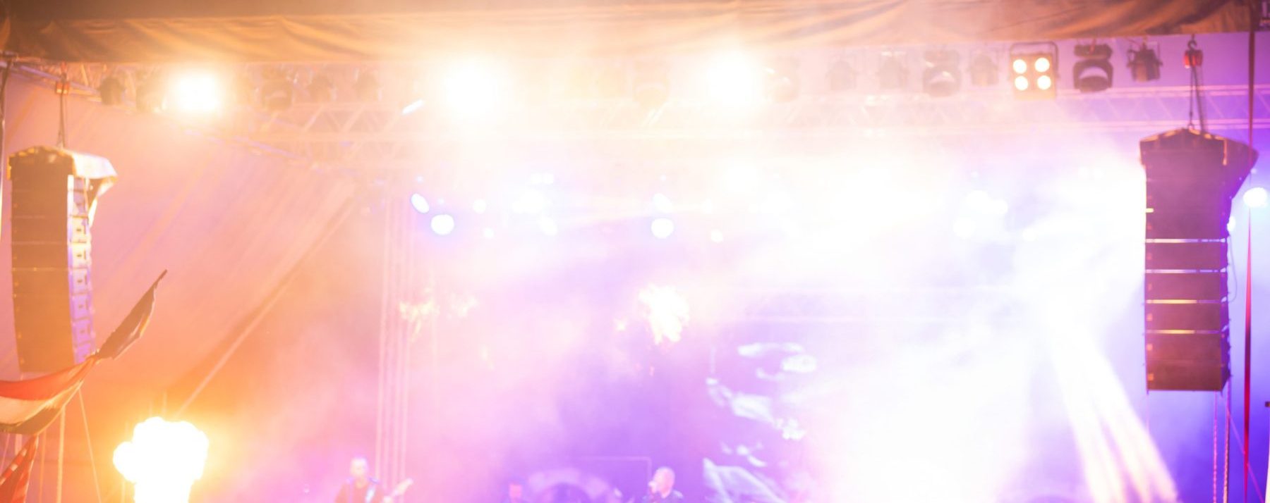 Concert stage with line-array speakers and lighting